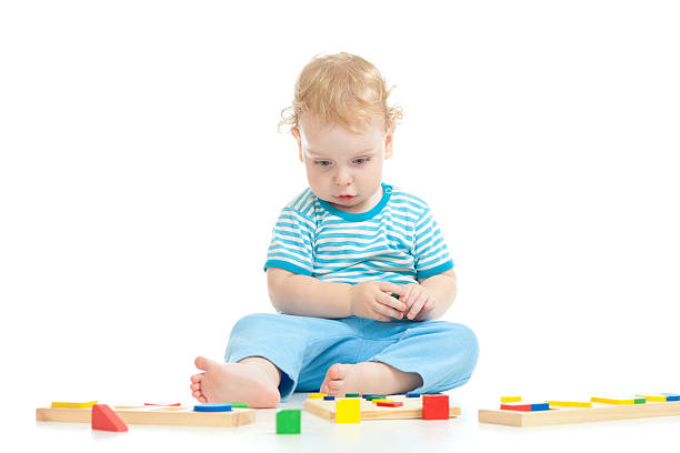 istock Serious pensive child playing logical education toys isolated 177428443