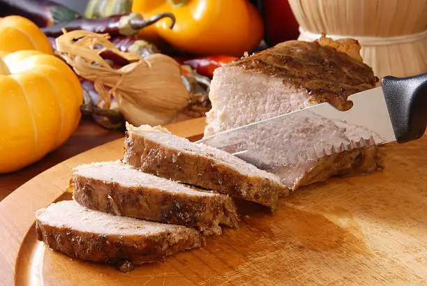 Roast pork  on a wooden board.