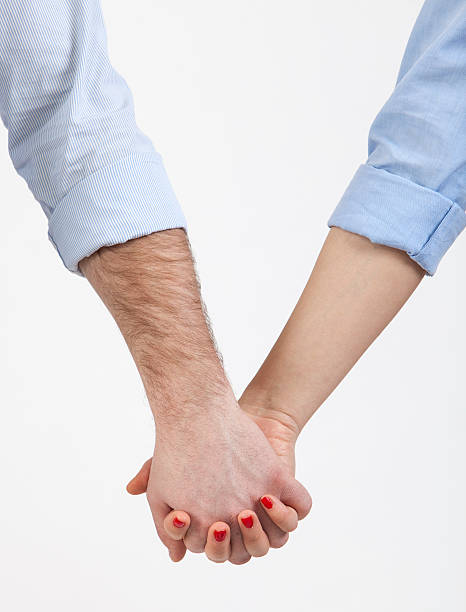 Holding Hands Close-up image of a couple holding hands with turned up sleeves.Take a look to my gallery of conceptual images: rolled up sleeves stock pictures, royalty-free photos & images