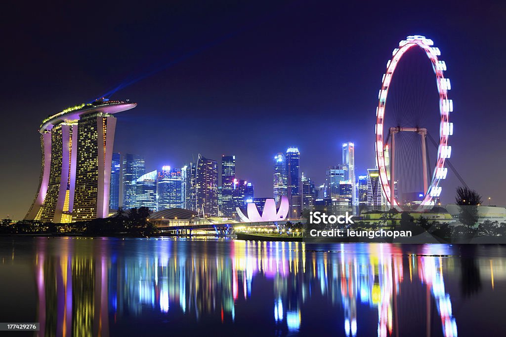 Lake reflecting the Singapore city skyline at night Singapore city skyline at night Singapore Stock Photo
