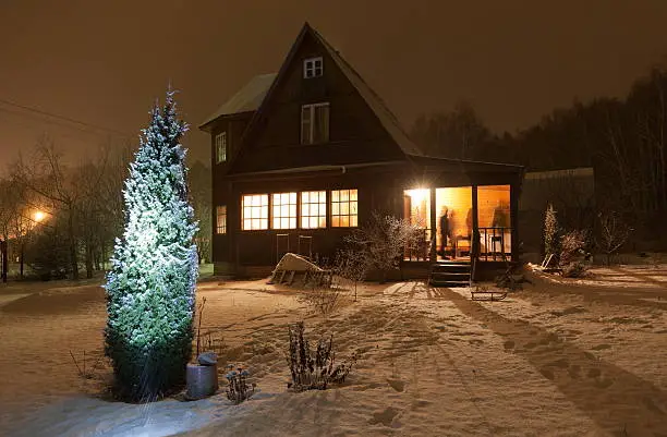 Russian county house (dacha) and decorated Christmas tree. Moscow region. Russia.