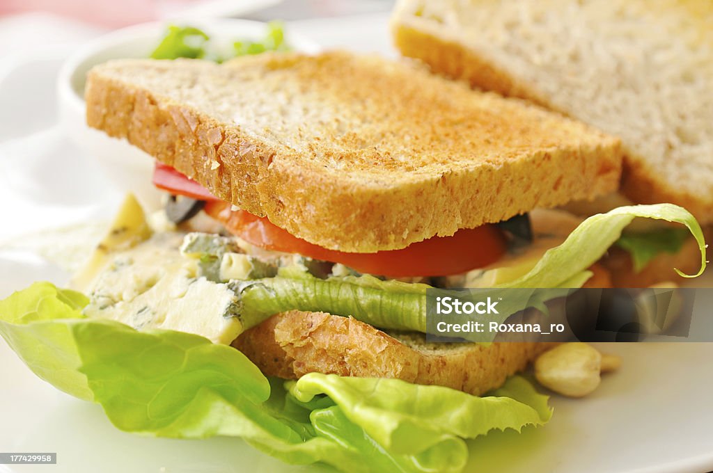 Sandwich in a cafe Sandwich with green salad, nuts, roasted bread, cheese in a cafe Baking Stock Photo