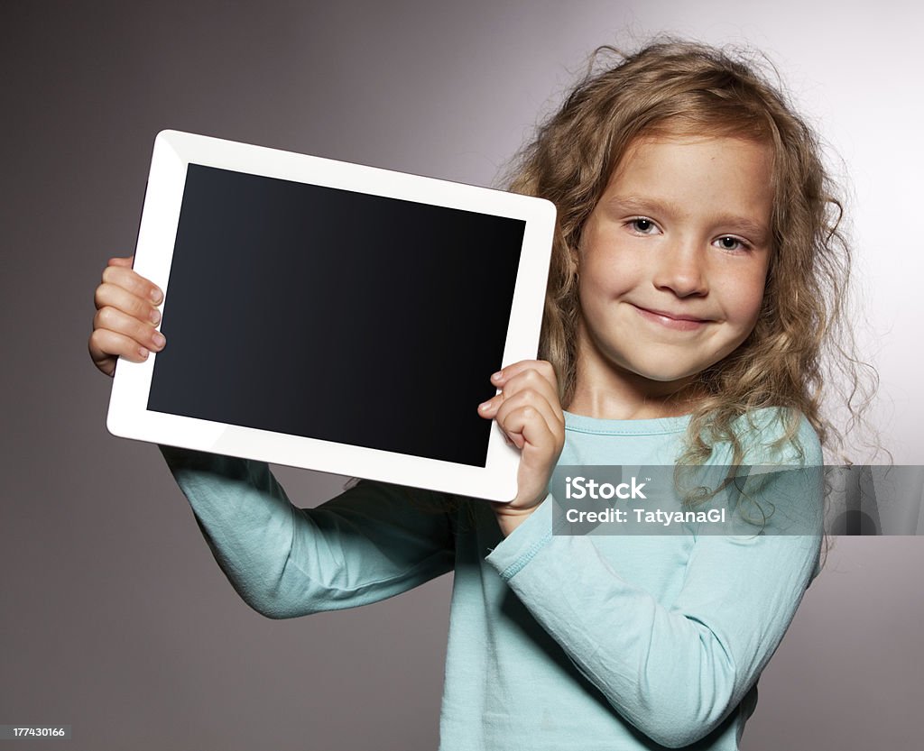 Happy girl with tablet computer Happy child with tablet computer. Kid showing Digital Tablet Stock Photo