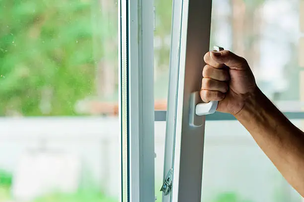 man opens the plastic window