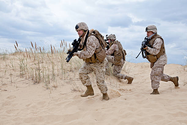 military operation US marines run through the desert through the military operation marine marpat uniform stock pictures, royalty-free photos & images