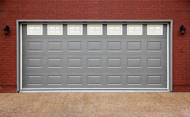 istock Garage with gray doors, brick wall and asphalt 177431858