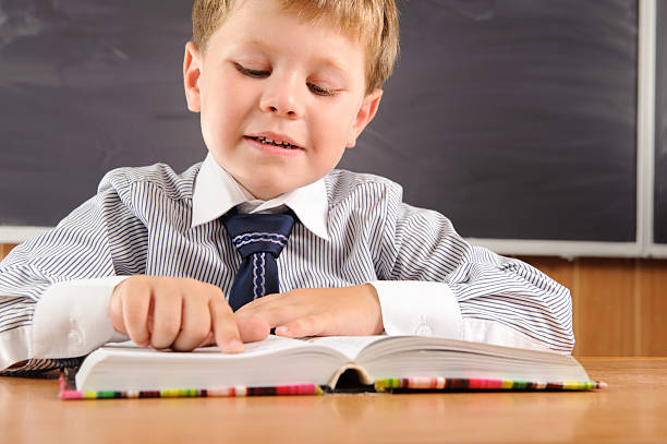 istock Cute boy with books at the desk 177433582