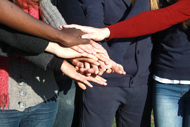istock hands of different races together 177434130