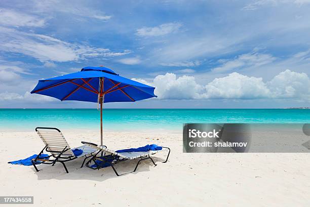 Two Chairs Under Umbrella Stock Photo - Download Image Now - Providenciales, Beach, Bay of Water