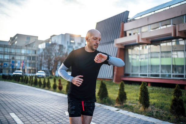 istock Man checks data on a fitness tracker while running 1774346900