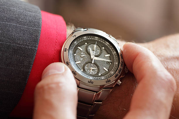 istock A man checking the time on his watch 177434748