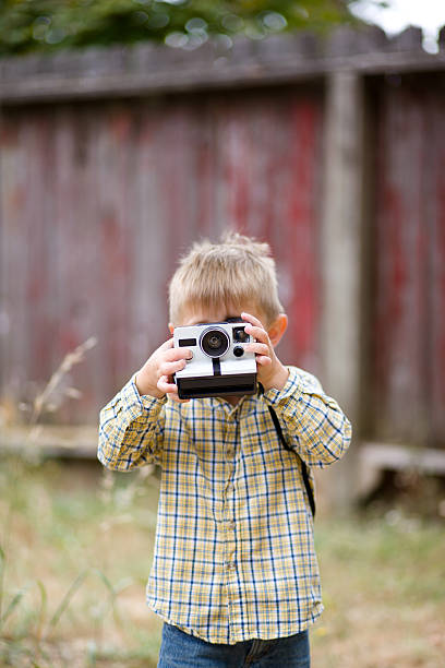 Little boy with polaroid camera stock photo