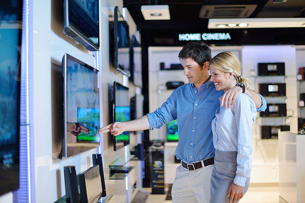 istock Young couple in consumer electronics store buy tv 177435130