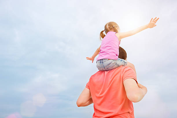 istock Father carrying his daughter on shoulders 177435825