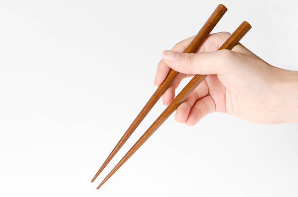 talher oriental - chopsticks human hand women isolated - fotografias e filmes do acervo