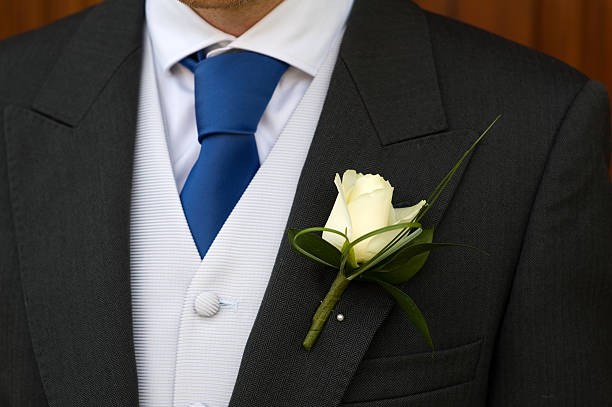 istock groom white rose buttonhole lapel of his wedding suit 177436018