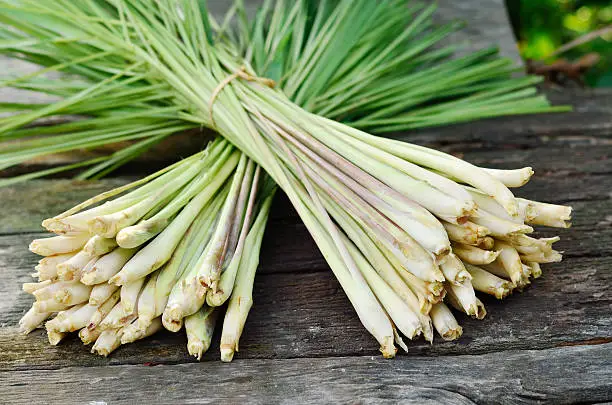 Two group of lemongrass for sale over wood background