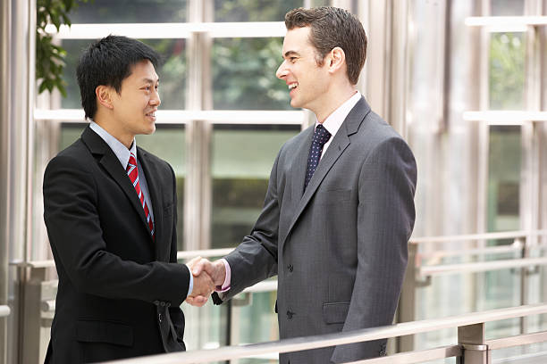 istock Two Businessmen Shaking Hands Outside Office 177436948