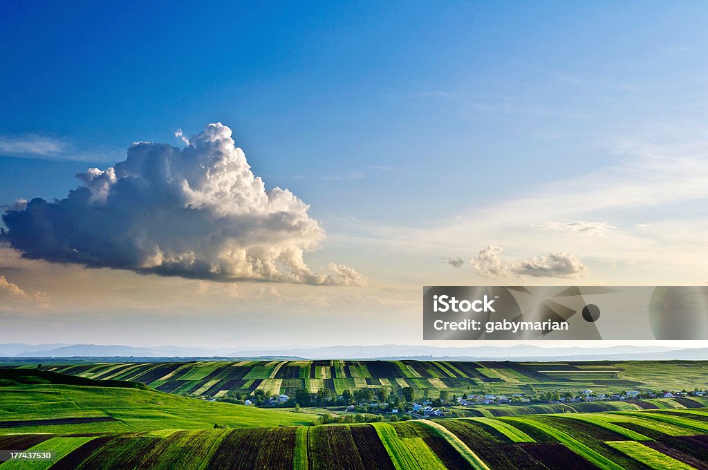 Walk in the clouds "Sunset view to Moara Carp village, Suceava County, Romania.This shot was published by National Geographic Traveler Magazine in march-april 2012 main edition." Agricultural Field Stock Photo
