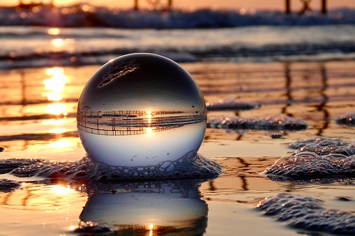 Crystal ball at beach during dawn