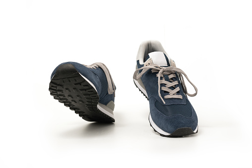 Blue sneakers walking isolated on white background, clipping path included
