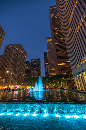 Vertical shot of an illuminated fountain at night outside 1251 Sixth Avenue, New York City, USA