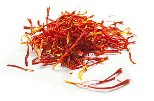 Close up photo of a pile of red saffron threads.