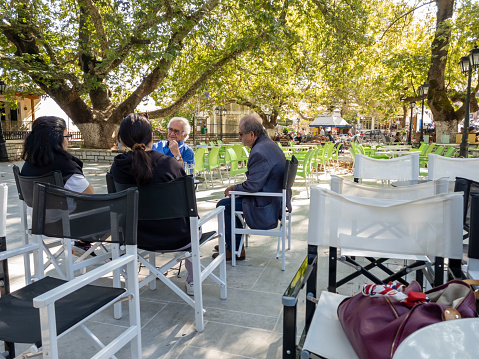 Lefkada island. Greece-10.07.2023. Tourists relaxing in an open cafe in Karya mountain village.