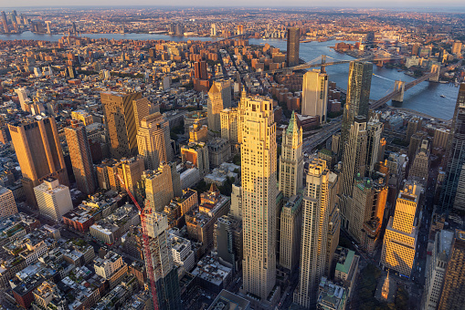 Aerial view of Lower Manhattan during sunset with the Brooklyn Bridge and Manhattan Bridge in the background, New York City, USA