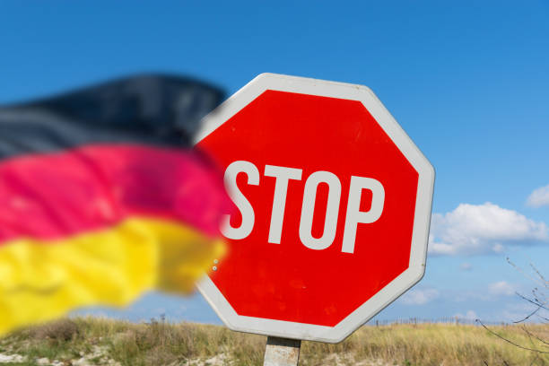 istock Flag of Germany and a stop sign 1774396140