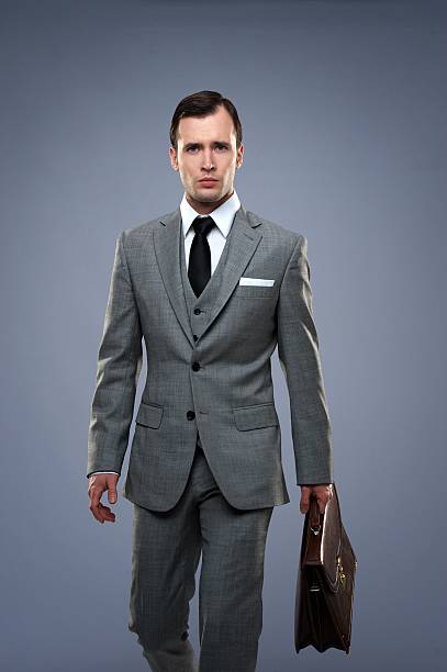istock Businessman with a briefcase isolated on grey 177440110
