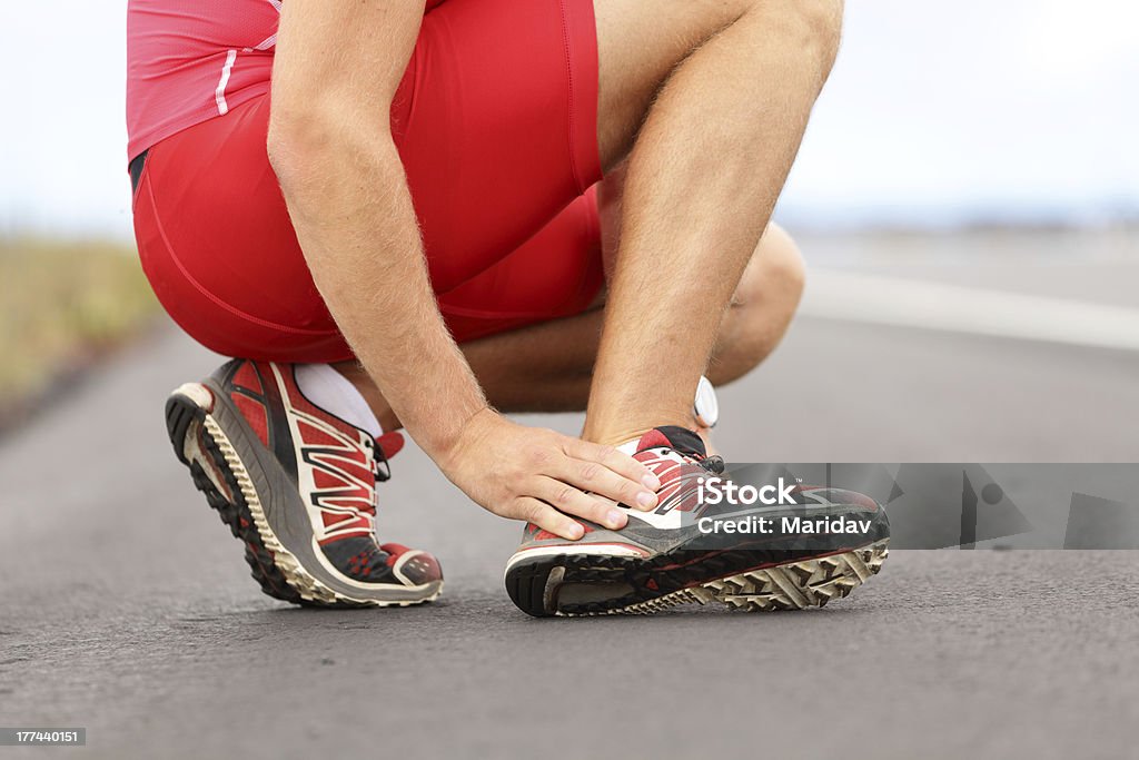 Twisted angle Broken twisted angle - running sport injury. Male runner touching foot in pain due to sprained ankle. Click for more: Human Foot Stock Photo