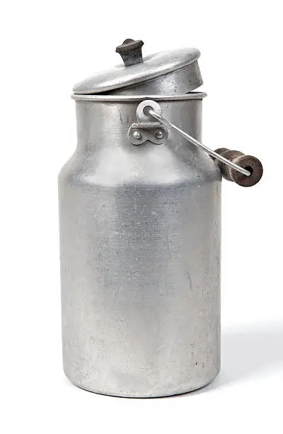 old milk can against white background