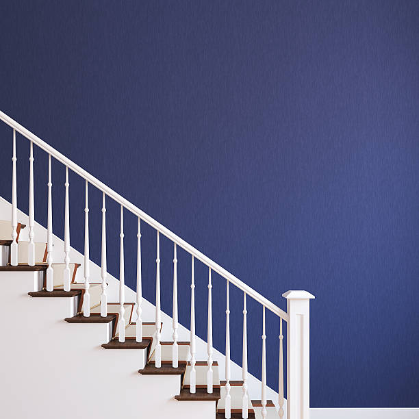 White stairway near a blue wall
