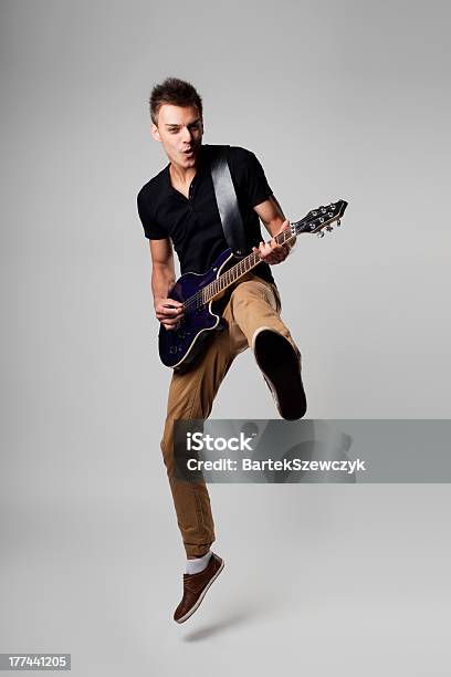 Rockstar Leap With Guitar Stock Photo - Download Image Now - Electric Guitar, Guitarist, Men