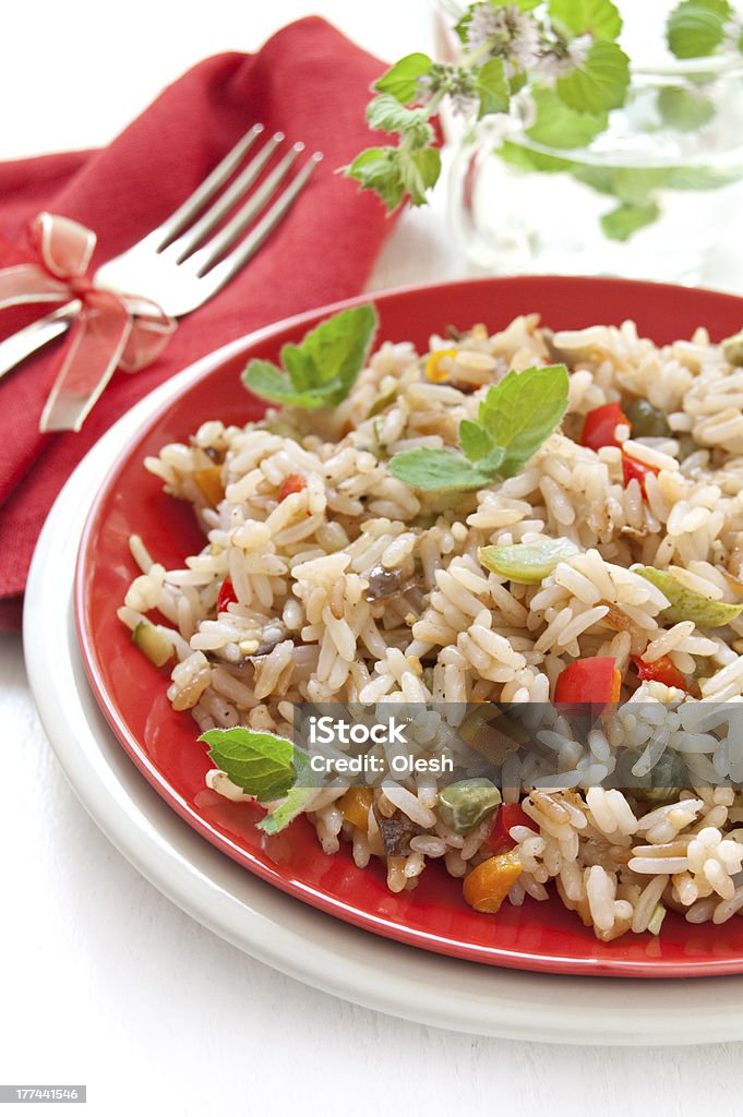 Vegetable Paella "Vegetable Paella in a red plate, restaurant menu" Basmati Rice Stock Photo