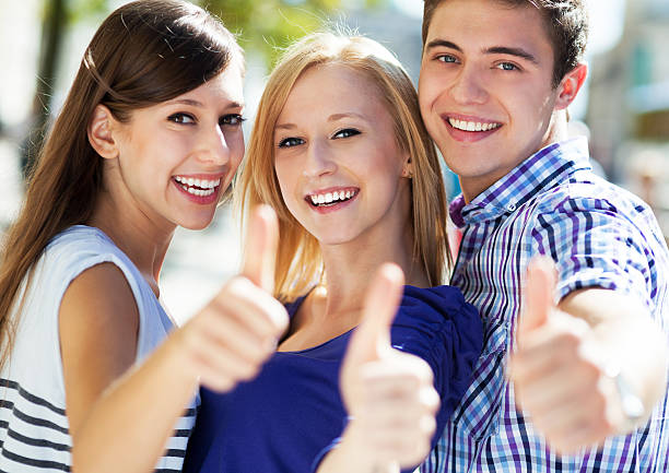 istock Three young friends with thumbs up 177441779