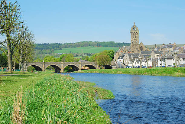 stone bridge over river Tweed and church tower at Peebles stock photo