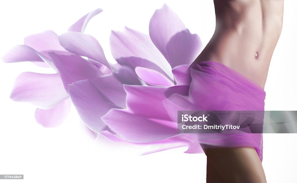 Beautiful woman with petals  on her hips Beautiful woman with pink petals  on her hips Flower Stock Photo