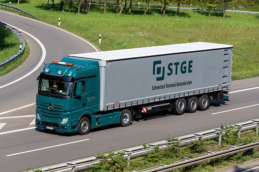 Wiehl, Germany - May 3, 2022: STGE Mercedes-Benz Actros truck with curtainside trailer on motorway