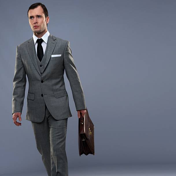 istock Businessman with a briefcase isolated on grey 177443040