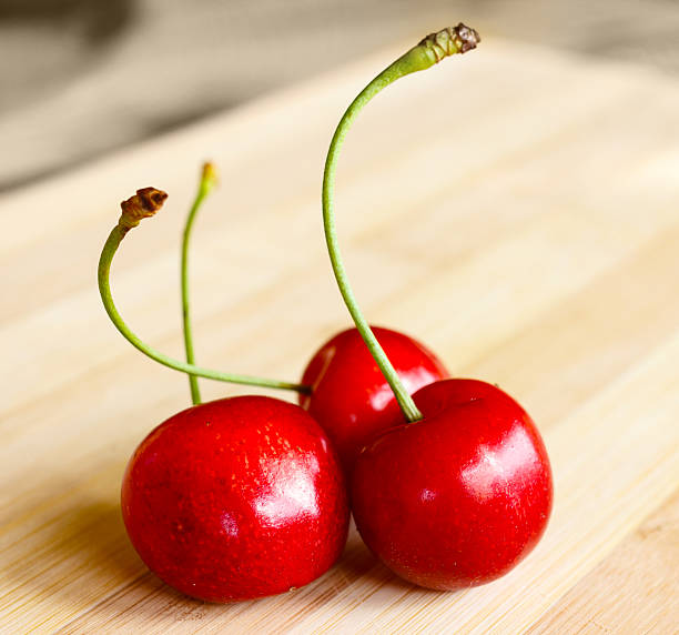 istock Bunch of fresh red cherries on wooden table 177443091