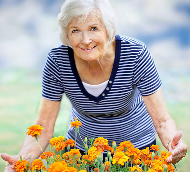 istock Senior woman  showing flowers 177443133
