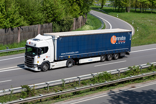 Wiehl, Germany - May 3, 2022: Transnaba Scania R450 truck with curtainside trailer on motorway
