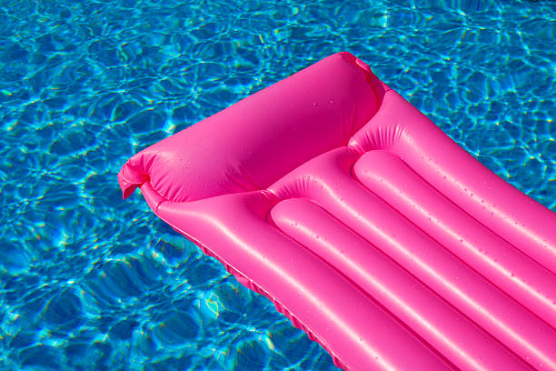 istock Pink air bed mattress in swimming pool 177443660