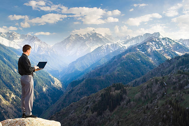 istock Young businessman using his laptop on the mountain top 177443742