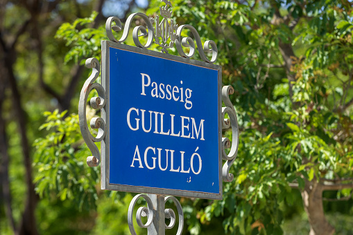 straat name sign of the Passeig de Guillem Agulló in the Real Gardens; Valencia, Spain