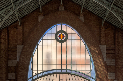 architectural detail of Mercado Central, an art nouveau building with a 30-metre-high dome and walls covered in traditional ceramic tiles, in the Spanish city of Valencia; Valencia, Spain