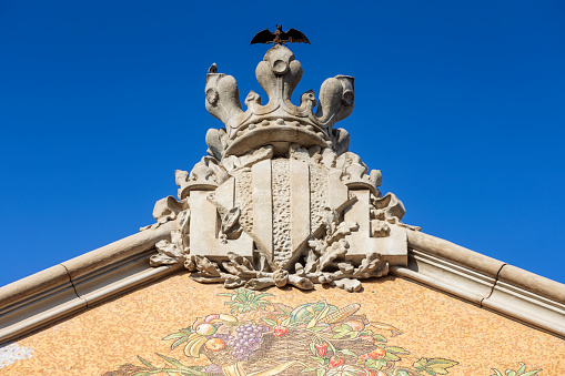 coat of arms of Valencia on the facade of Mercado Central, an art nouveau building with a 30-metre-high dome and walls covered in traditional ceramic tiles, in the Spanish city of Valencia; Valencia, Spain