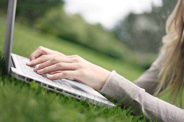 istock Working on a laptop in the grass 177444429